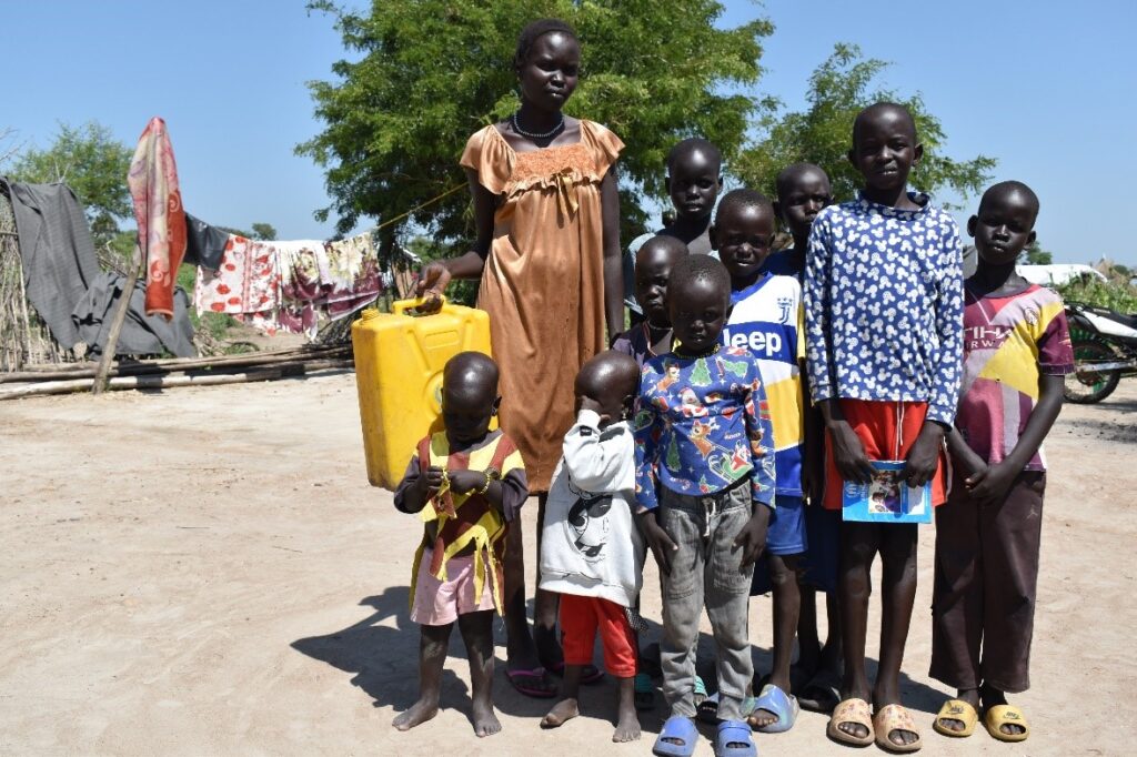 Nyapieri in the company of her children within the comfort of their home